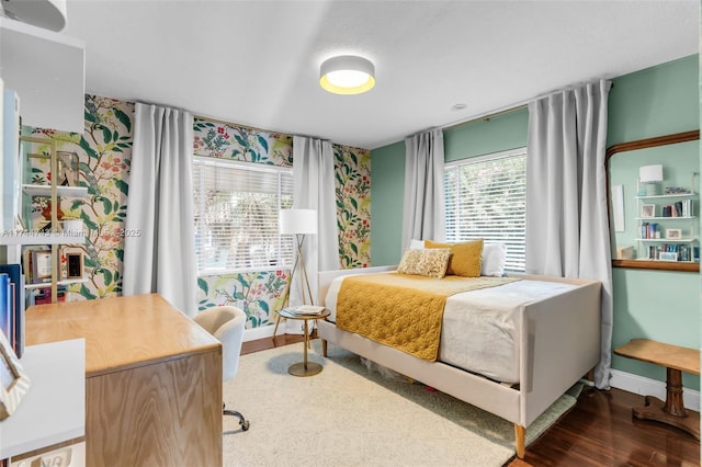 bedroom featuring dark wood-style floors and baseboards