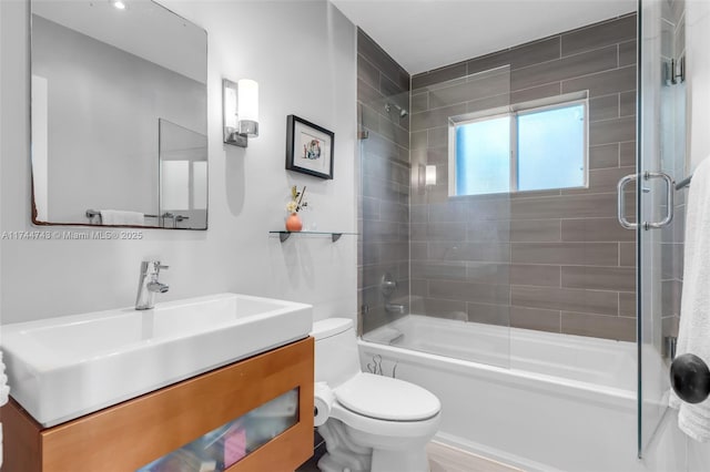 bathroom featuring toilet, tub / shower combination, and vanity