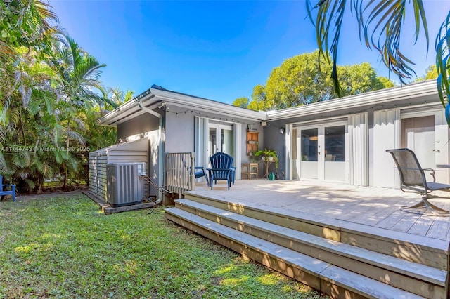 back of house featuring a wooden deck, central AC unit, a lawn, and french doors