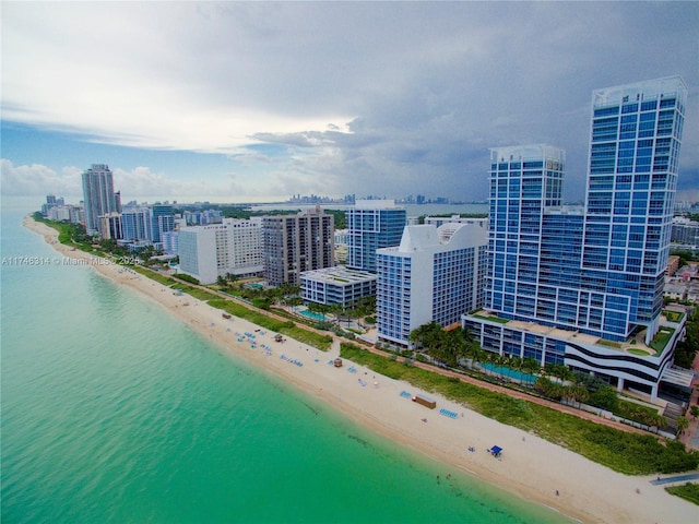 birds eye view of property with a view of the beach and a water view