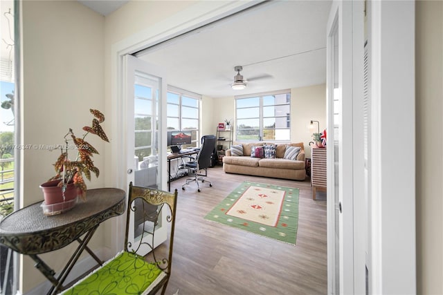 home office with ceiling fan and wood finished floors