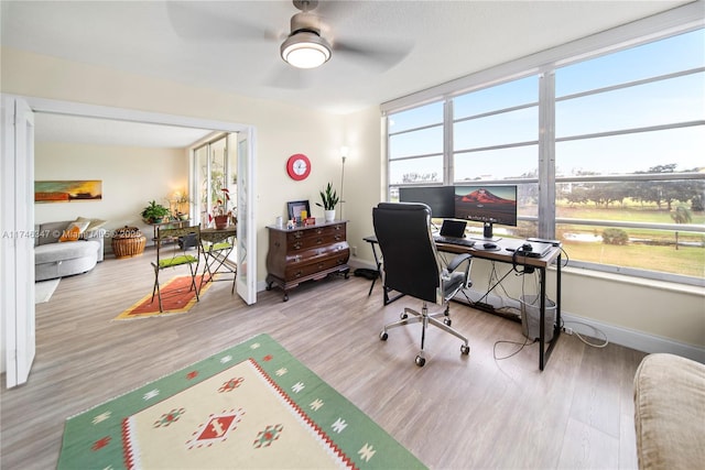 office space featuring ceiling fan, baseboards, and wood finished floors