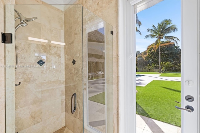 bathroom featuring a shower with door and a healthy amount of sunlight