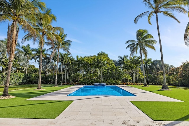 view of swimming pool with a yard and a patio area