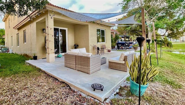 3772 NE 9th Ct, Homestead, FL 33033 - rear view of property featuring stucco siding, a patio area, an outdoor hangout area, and a lawn