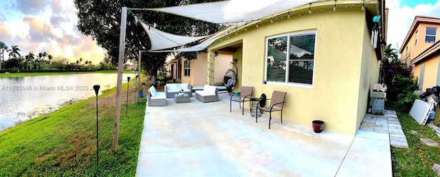 view of patio / terrace with an outdoor living space and a water view