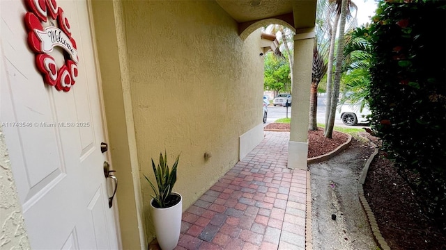 view of exterior entry with stucco siding