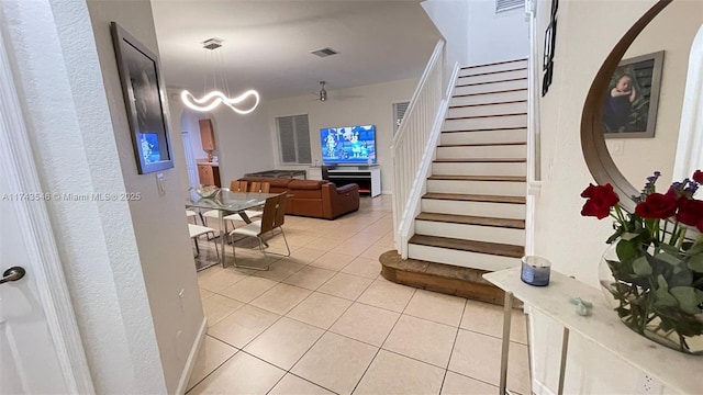 staircase with tile patterned floors and visible vents