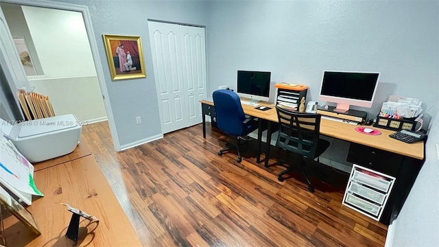 home office featuring wood finished floors and baseboards