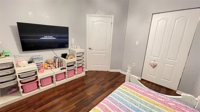 bedroom featuring dark wood-type flooring and baseboards