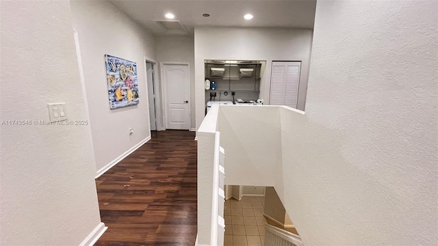 hall featuring recessed lighting, baseboards, dark wood-style flooring, and a textured wall