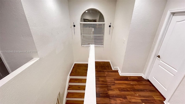 stairs with baseboards and wood finished floors