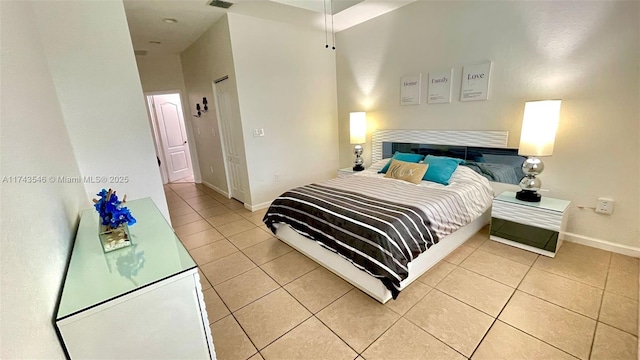 bedroom with light tile patterned floors, visible vents, and baseboards