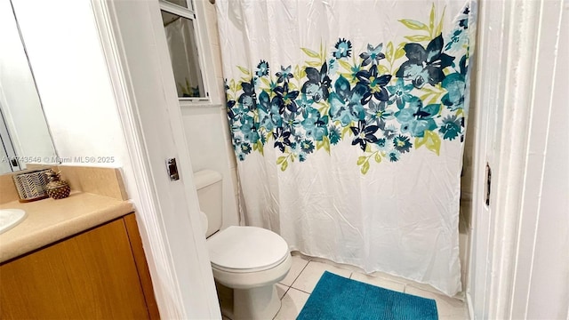 full bathroom featuring tile patterned flooring, toilet, and vanity