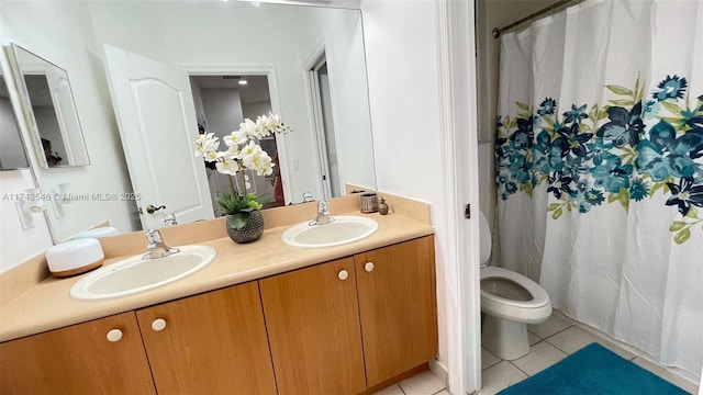 full bathroom featuring tile patterned floors, toilet, double vanity, and a sink