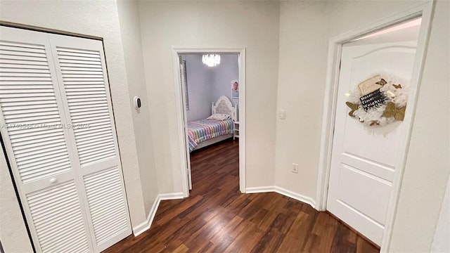 hall featuring dark wood-style floors and baseboards