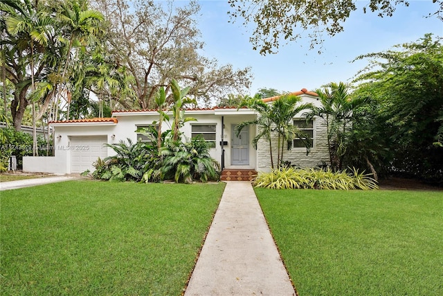 view of front of house with a garage and a front yard