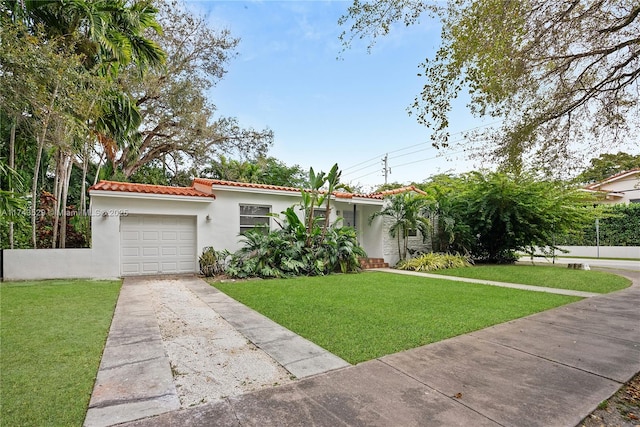 view of front of property featuring a garage and a front lawn