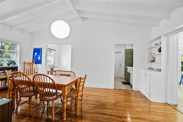 dining room with wood ceiling, light hardwood / wood-style floors, and vaulted ceiling with beams