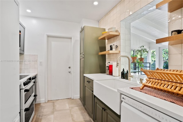 kitchen with beam ceiling, sink, white appliances, and decorative backsplash