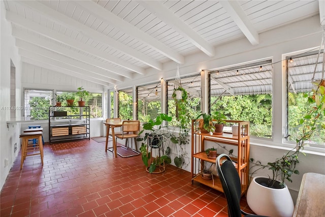 sunroom / solarium with vaulted ceiling with beams