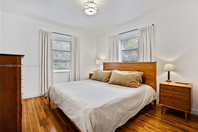 bedroom featuring multiple windows and wood-type flooring