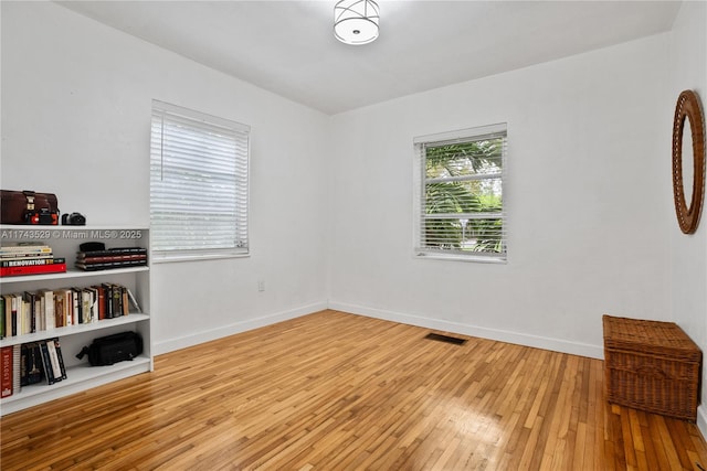unfurnished room with light wood-type flooring