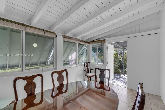 sunroom / solarium featuring vaulted ceiling with beams and wooden ceiling