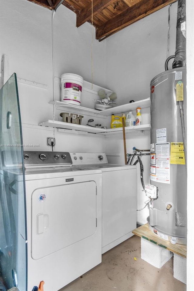 clothes washing area with gas water heater and washer and dryer