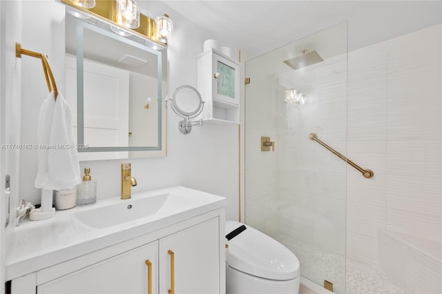 bathroom with vanity, a tile shower, and toilet