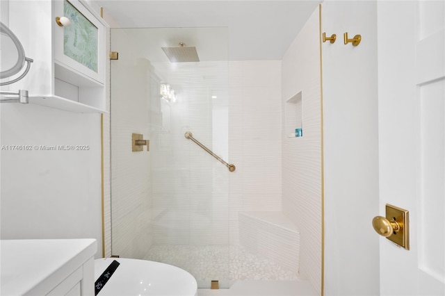 bathroom with vanity and tiled shower