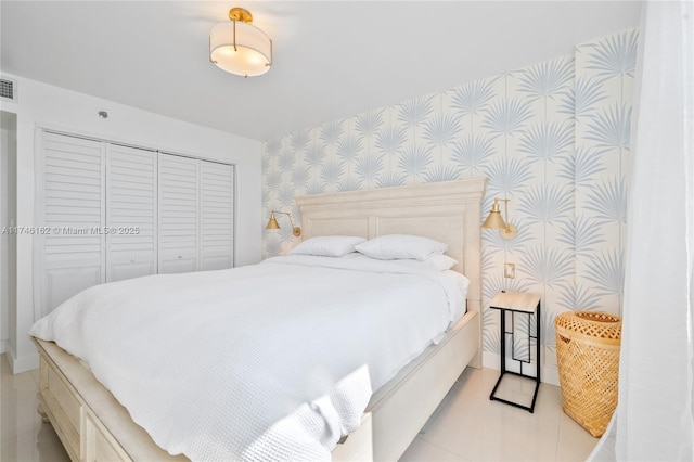 bedroom featuring light tile patterned floors and a closet