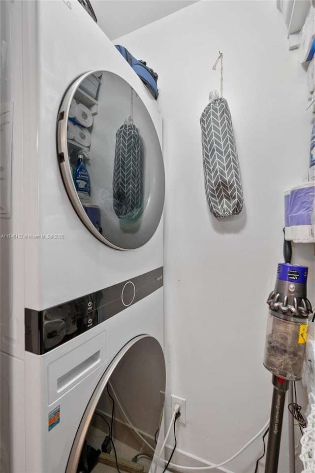 clothes washing area featuring stacked washer and dryer