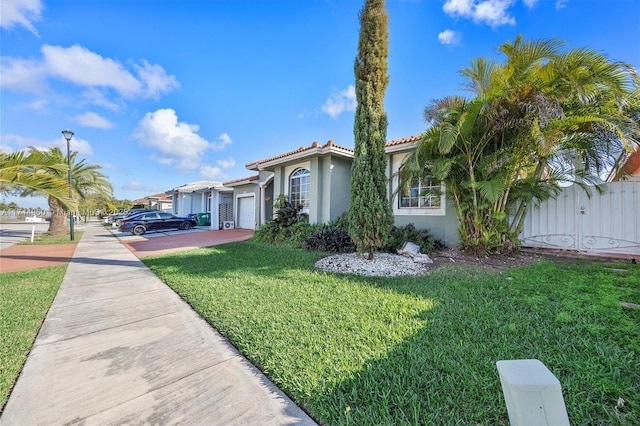 view of front of property featuring a garage and a front yard