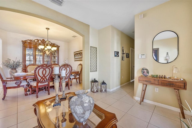 tiled dining area featuring a chandelier