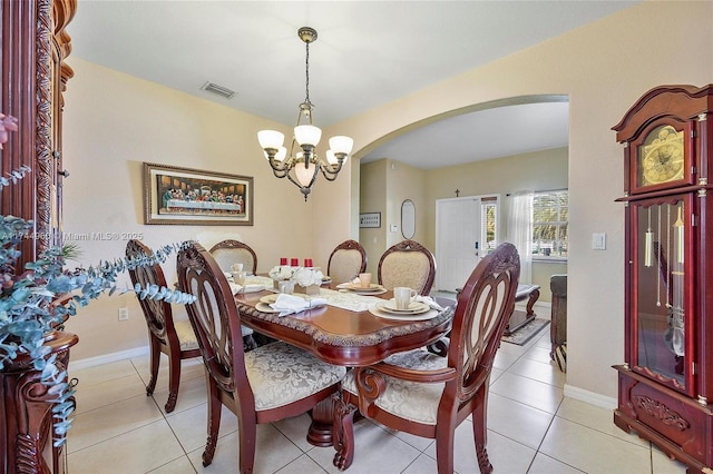dining space with an inviting chandelier and light tile patterned floors