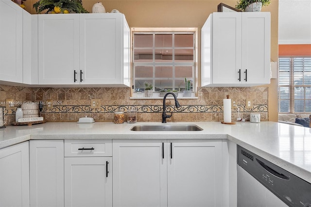 kitchen with dishwasher, sink, decorative backsplash, and white cabinets