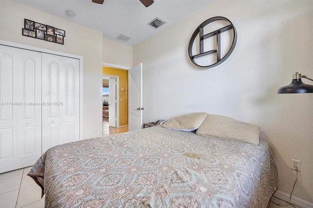 tiled bedroom featuring ceiling fan and a closet
