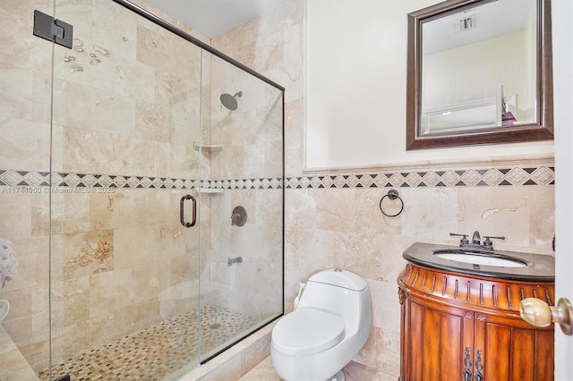 bathroom featuring a shower with door, vanity, and toilet