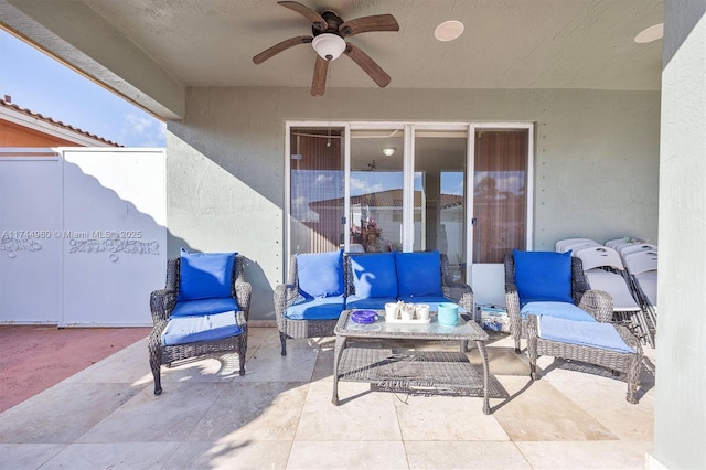 view of patio with an outdoor living space and ceiling fan