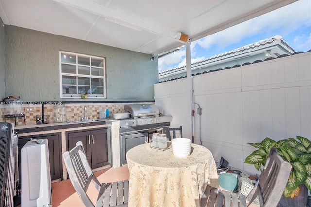 view of patio / terrace featuring area for grilling, an outdoor wet bar, and exterior kitchen