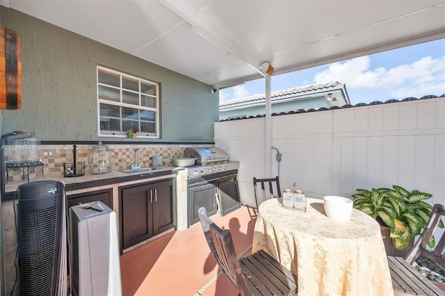 view of patio / terrace with a grill, an outdoor kitchen, and an outdoor wet bar