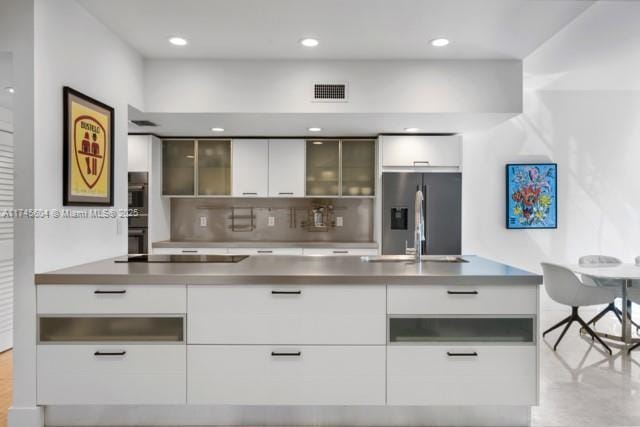10655 NE Quaybridge Ct Unit C3, Miami, FL 33138 - kitchen featuring stainless steel refrigerator with ice dispenser, modern cabinets, black electric stovetop, white cabinetry, and recessed lighting