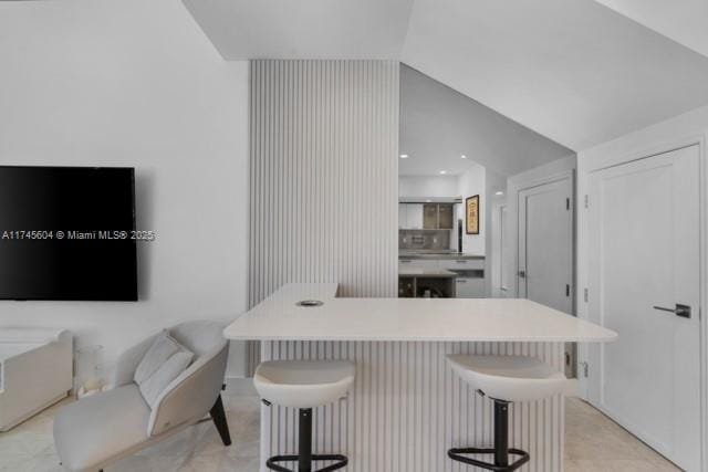 10655 NE Quaybridge Ct Unit C3, Miami, FL 33138 - kitchen with a kitchen breakfast bar, light countertops, a center island, vaulted ceiling, and open floor plan