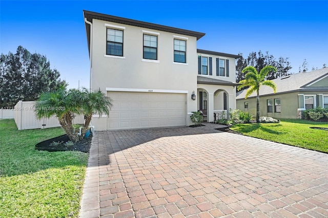 view of front of property featuring a garage and a front lawn