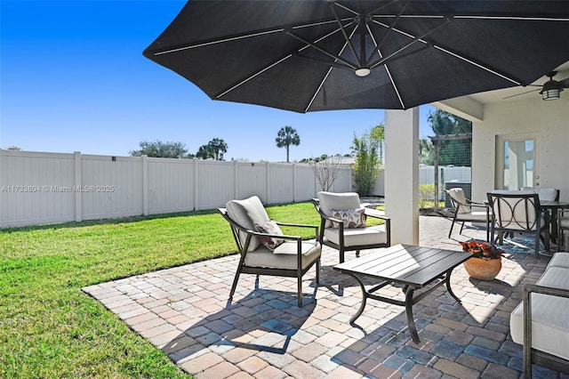 view of patio featuring ceiling fan