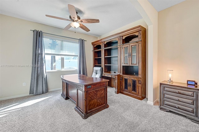 office space with ceiling fan and light carpet