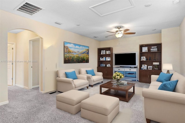 carpeted living room featuring a textured ceiling