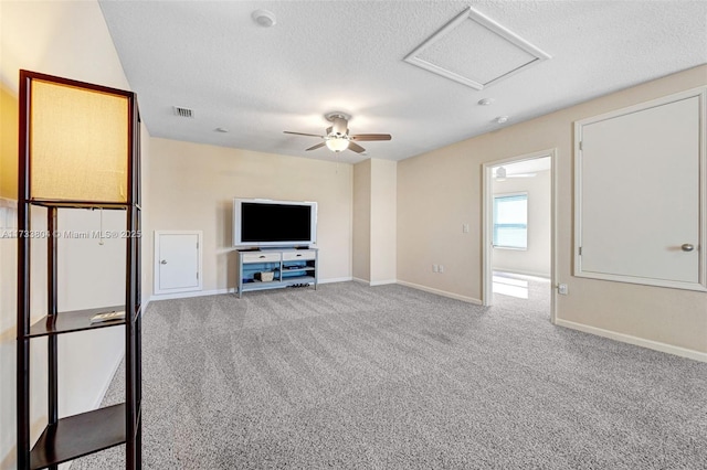 unfurnished living room featuring light carpet and a textured ceiling