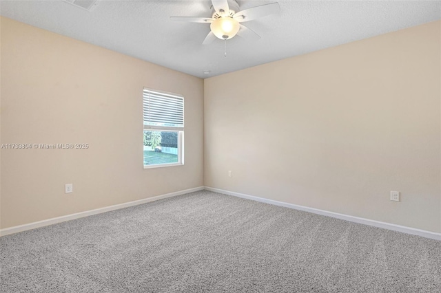 unfurnished room with ceiling fan, carpet floors, and a textured ceiling